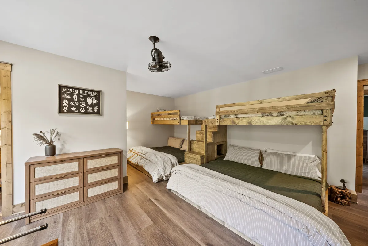 A playful bunk bed setup with a chest of drawers and charming wall decor, creating a vibrant and inviting space for children or family gatherings. The design encourages togetherness, storytelling, and making memories across generations.
